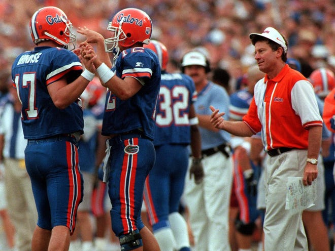 Steve Spurrier talks to quarterbacks Noah Brindise, left, and Doug Johnson during a game against Florida State in 1997.