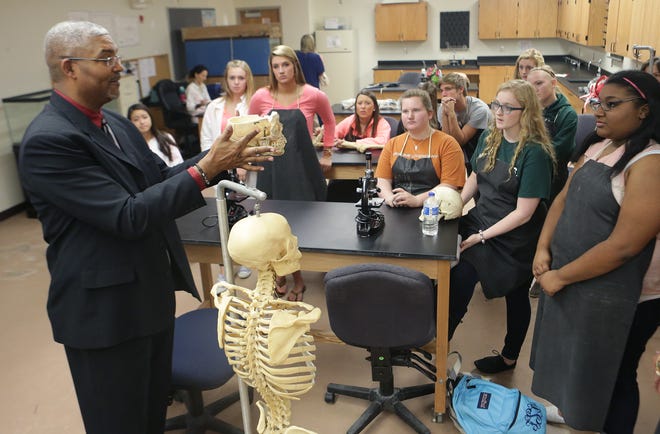 Dr. John Wade reviews cranial bones with Mosley High School Honors anatomy students on Oct. 9. in Lynn Haven. “Our kids will be at least four years ahead of the game when they start college,” he said.