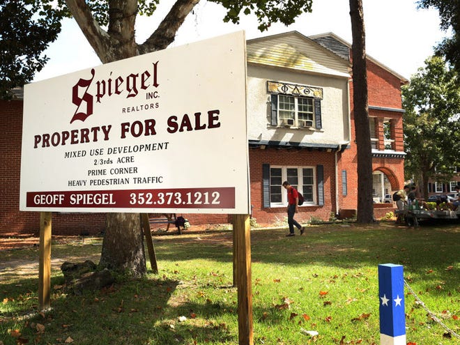 A “for sale” sign sits outside the Phi Delta Theta fraternity house across from the University of Florida campus on Monday.