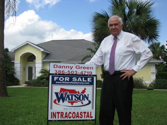 Danny Green, a real estate agent with Watson Realty Corp. in Palm Coast, stands in front of a four-bedroom riverfront house for sale in Flagler Beach. The asking price is $685,000. Green is the property’s listing agent.