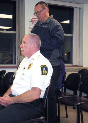 Ron Hess, Jr., standing, speaks on behalf of the newly reorganized Herkimer Business and Professional Association during Monday’s village board meeting. Seated is Police Chief Joseph Malone. TELEGRAM PHOTO/DONNA THOMPSON