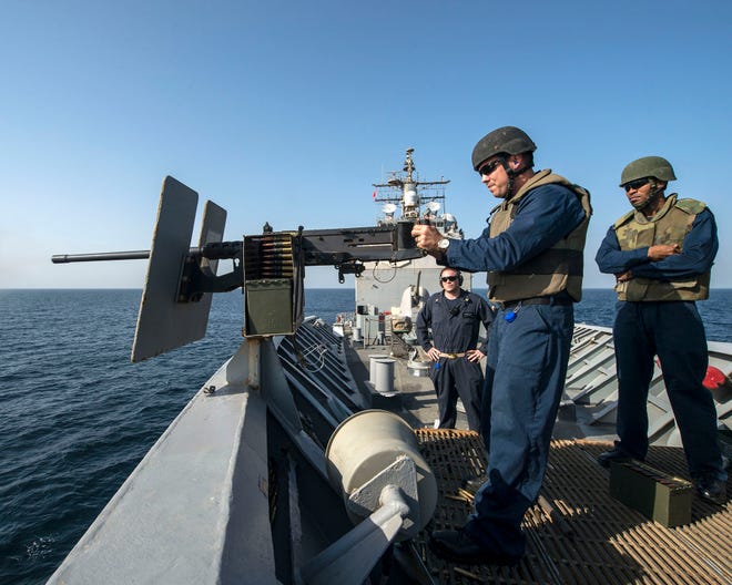 Gunner's Mate 1st Class Michael Graf fires a .50-caliber machine gun during a live fire exercise aboard USS Philippine Sea (CG 58). Phil Sea is deployed as part of the George H.W. Bush Carrier Strike Group supporting maritime security operations and theater security cooperation efforts in the U.S. 5th Fleet AOR.
