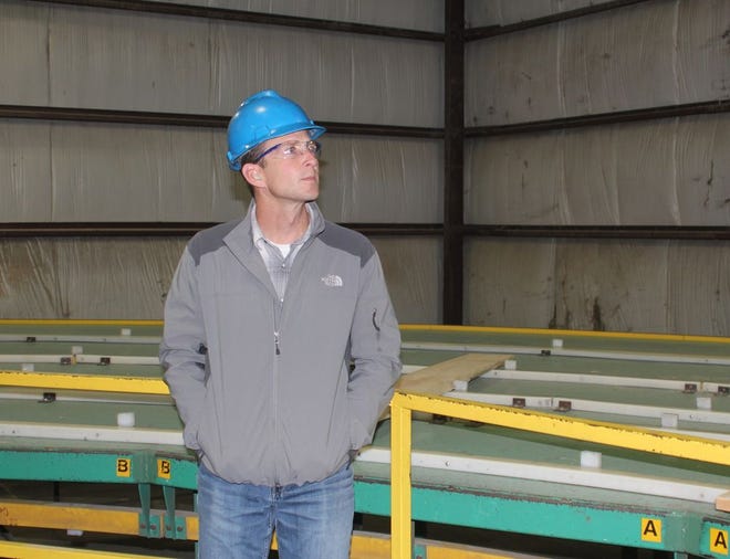 Devereaux Sawmill General Manager Todd Smith inspects lumber during a tour Wednesday afternoon for Michigan Department of Agriculture and Rural Development and Michigan Economic Development Cooperation staff.