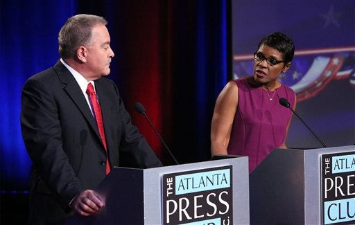 Republican Richard L. Woods, left, and Democrat Valarie Wilson square off once again during a Atlanta Press Club sponsored debate as they campaign to be Georgia's next superintendent at the Georgia Public Broadcasting studios in Atlanta on Sunday, Oct. 12, 2014. (AP Photo/Atlanta Journal-Constitution, Phil Skinner)