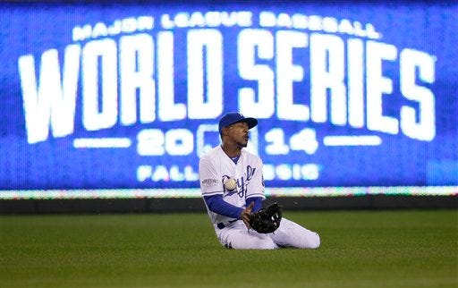 Kansas City Royals center fielder Jarrod Dyson can not catch a hit by San Francisco Giants Buster Posey during the sixth inning of Game 2 of baseball's World Series Wednesday, Oct. 22, 2014, in Kansas City, Mo. (AP Photo/Charlie Neibergall)