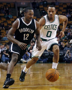 Guard Marquis Teague (12) drives against the Celtics' Avery Bradley (0) during an NBA preseason game Wednesday. The Sixers acquired Teague from the Nets on Friday.