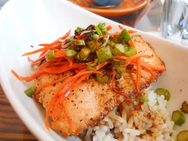 The Wild Salmon Curry at Octane Interlounge features red curry, pan-fried wild salmon, jasmine rice, ginger and scallions, garlic, coconut milk, asparagus and carrots.