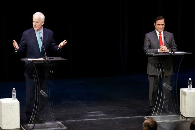U.S. Sen. John Cornyn, R-Texas, left, responds to a question during a debate against Democratic U.S. Senate candidate David Alameel at Mountain View College campus, Friday, Oct. 24, 2014, in Dallas. (AP Photo/Tony Gutierrez)