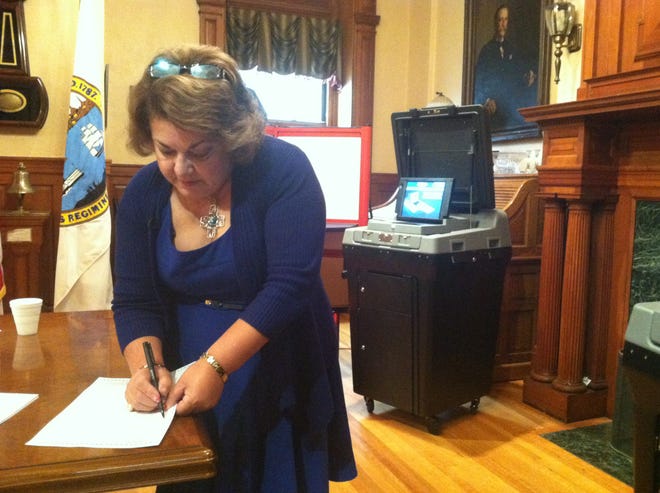 New Bedford Election Commissioner Maria Tomasia fills out a ballot with questions like "Who is your favorite singer?" to test the new voting machines. JONATHAN CARVALHO/THE STANDARD-TIMES