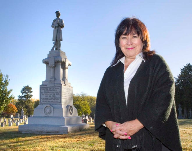 Deb Goodrich Bisel, resident historian at the Topeka Cemetery, stands in front of the Gage Monument. The monument notes the soldiers of the Topeka Battery who were killed in the Battle of the Blue in October 1864. The cemetery is marking the 150th anniversary with events on Oct. 30.
