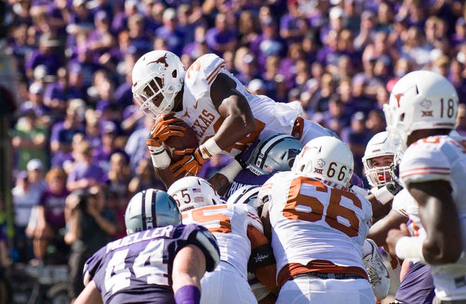Texas running back Johnathan Gray tries to leap over the K-State defense on third down in the second half on Saturday, October 25, 2014 at Bill Snyder Family Stadium. Gray was short and fell short again on the fourth down try as K-State defeated Texas 23-0.