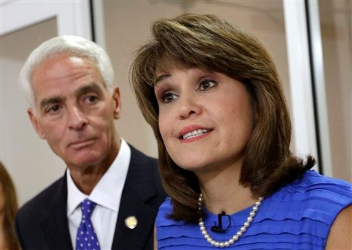 FILE - In this July 17, 2014 file photo, Annette Taddeo-Goldstein, right, talks to reporters during a news conference as former Gov. Charlie Crist listens in Miami. Crist picked former congressional candidate and Miami-Dade County Democratic Party chairwoman Annette Taddeo-Goldstein as his running mate. After years of running few Latinos for statewide posts, Democrats are building a bench that better reflects the support they have in the Hispanic community: more than twice as many Hispanics identify as Democrats than Republicans nationally, according to polls. This year they are showcasing this bench in key states that not only have large Hispanic electorates but enough electoral votes to swing presidential elections. The shift is crucial for a party that often fails to get its Hispanic supporters to the polls. (AP Photo/Alan Diaz)