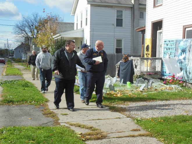 Herkimer Mayor Tony Brindisi, left front, and Fire Chief John Spanfelner lead a contingent of village officials on a “Quality of Life” sweep in the southeastern portion of the village. Participants looked for safety and codes issues as well as unsightly areas. TELEGRAM PHOTO/DONNA THOMPSON