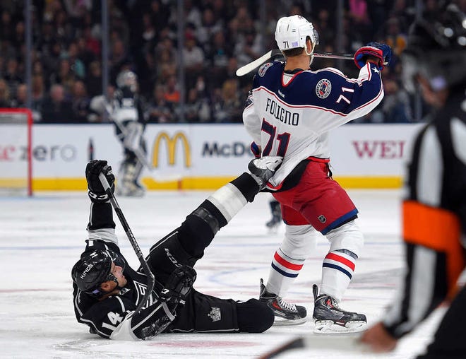 Los Angeles Kings right wing Justin Williams, left, gets his skate caught in the jersey of Columbus Blue Jackets left wing Nick Foligno during the second period of an NHL hockey game, Sunday, Oct. 26, 2014, in Los Angeles. (AP Photo/Mark J. Terrill)