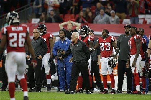Atlanta Falcons head coach Mike Smith argues with an official in the second half of the NFL football game against the Detroit Lions at Wembley Stadium, London, Sunday, Oct. 26, 2014. The Lions won 22-21. (AP Photo/Matt Dunham)