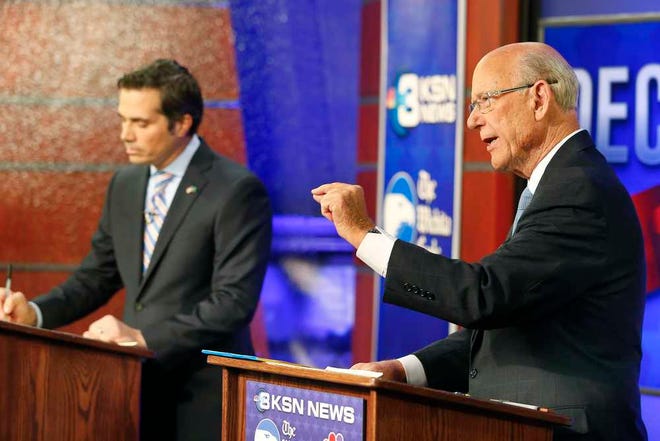 Sen. Pat Roberts, right, talks about the farm bill while debating against independent candidate Greg Orman during their second debate Wednesday night at the KSN studios in Wichita.