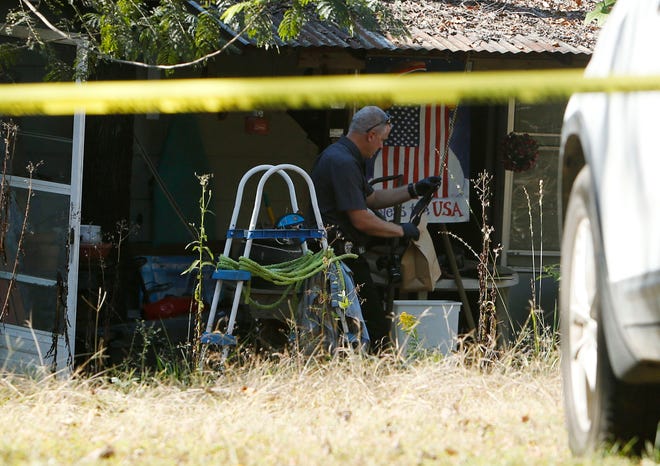 Investigator Simon Miller, works the scene of a shooting that occurred Monday afternoon off of Hargrove Road East in Tuscaloosa, Ala. on Monday Oct. 27, 2014. staff photo | Erin Nelson