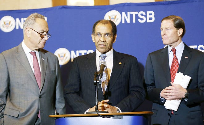Christopher Hart, acting chairman of the National Transportation Safety Board, center, speaks while surrounded by senators Chuck Schumer (D-NY), left, and Richard Blumenthal (D-CT) during a news conference in New York Tuesday. A sleep-deprived engineer nodded off at the controls of a commuter train just before taking a 30 mph curve at 82 mph, causing a derailment last year that killed four people and injured more than 70, federal regulators said Tuesday. William Rockefeller's sleepiness was due to a combination of an undiagnosed disorder, sleep apnea and a drastic shift in his work schedule, the National Transportation Board said. AP PHOTO/SETH WENIG