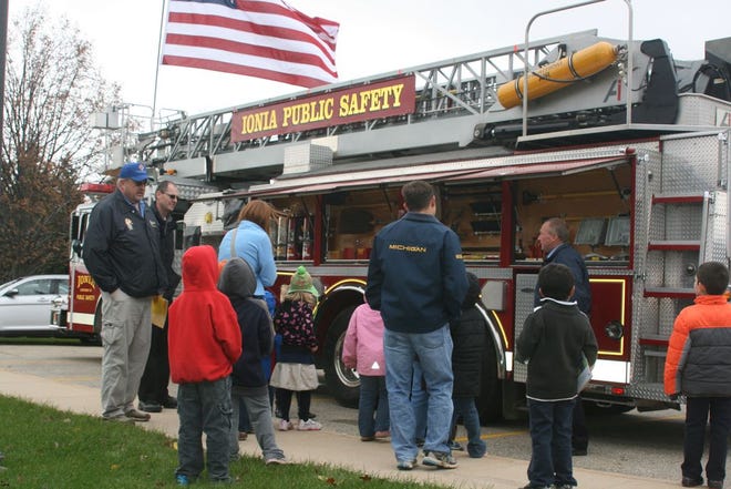 Students from SS. Peter and Paul School view the equipment carried on the Ionia Department of Public Safety fire truck Wednesday.