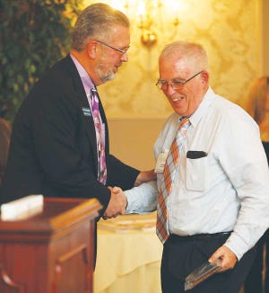 Photo by Daniel Freel/New Jersey Herald - Kevin Prendergast, vice president of Lakeland Bank, left, presents Jonathan Andrews, of Springboard Shoppes, with Chamber Member of the Year Award during the Greater Newton Chamber of Commerce awards dinner.