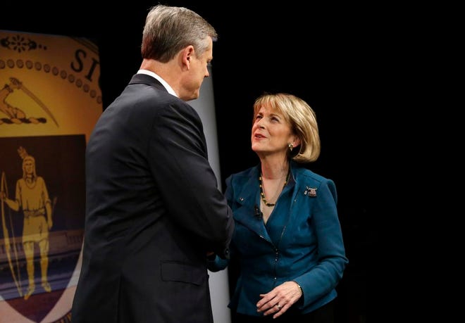 Massachusetts gubernatorial candidates Charlie Baker and Martha Coakley shake hands moments before a televised debate in Needham on Tuesday, Oct. 28, 2014.