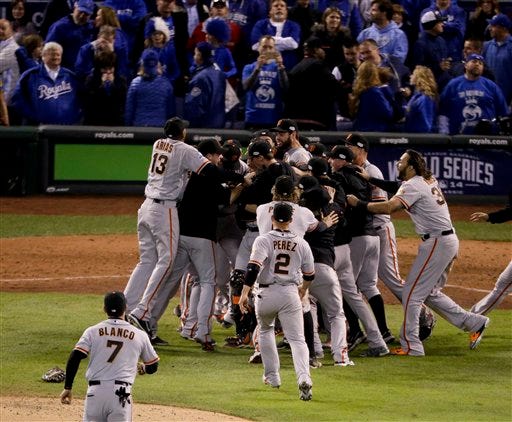 Members of the San Francisco Giants celebrate their 3-2 win against the Kansas City Royals in Game 7 of baseball's World Series Wednesday, Oct. 29, 2014, in Kansas City, Mo. (AP Photo/Charlie Riedel)