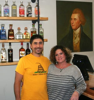 Mark and Stacey Marchionni, seen here alongside American Revolutionary Thomas Jefferson, have opened a restaurant and upscale bar called the Revolution Taproom and Grill. Mark’s T-shirt features the Gadsden flag, designed during the American Revolution.
