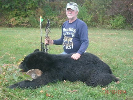 Dan Smart with the bear he took with a bow Oct. 12.