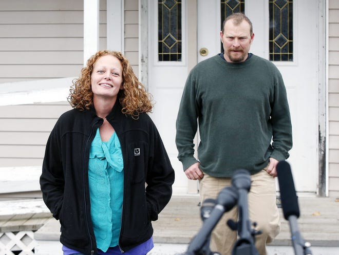 Kaci Hickox and her boyfriend Ted Wilbur come out of their house to speak to reporters Friday in Fort Kent, Maine. Hickox, a nurse who defied an Ebola quarantine in the state of Maine after treating patients in West Africa, can travel unrestricted after a judge rejected the state's bid to limit her movements. Judge Charles C. LaVerdiere said Friday that Hickox must continue daily monitoring and co-ordinate travel with state officials so monitoring can continue. But the judge said there's no need for further restrictions because she's not infectious. AP PHOTO/ROBERT F. BUKATY