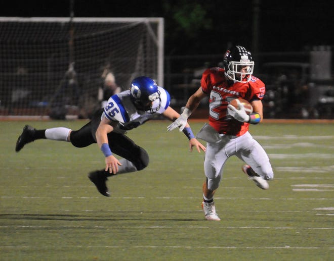 Central Bucks East's Alex Gibson outruns Quakertown's Bobby Boyd during Central Bucks East's home game in Doylestown Friday evening. (Catherine Meredith/Staff Photographer)