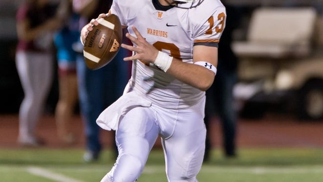 Westwood quarterback Jack Swensen rolls out against Round Rock on Friday night. The Dragons won 52-7. CREDIT: Henry Huey/For American-Statesman