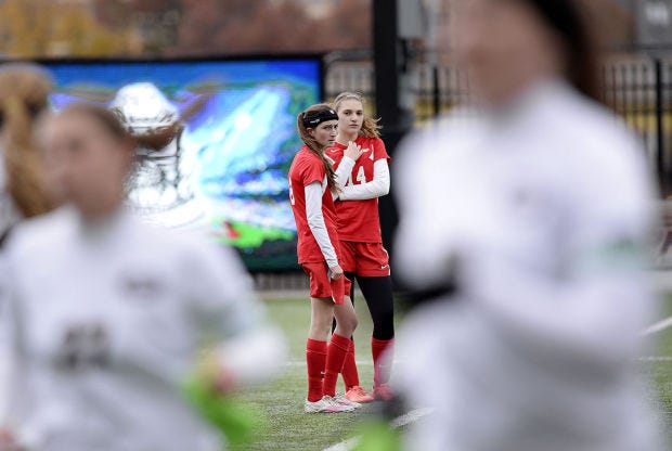Freedom’s Lyndsey Kauffman and Alexa Schwab watch as Greensburg Central Catholic’s starters run off the field during the second half of Saturday’s Class A championship.