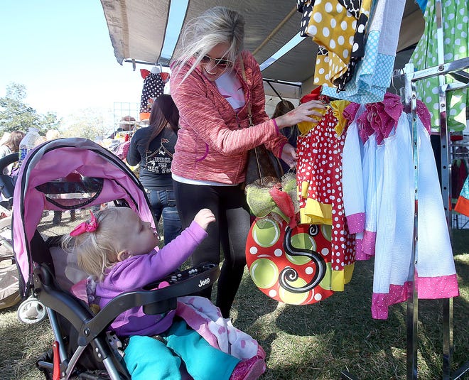 Brooke Skipworth and her daughter Finley, 1, look over dresses Saturday at the Southdown Marketplace.