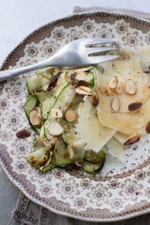This Sept. 8 photo shows grilled zucchini ribbons with Parmesan and toasted almonds in Concord. The grilled zucchini ribbons add both flavor and visual appeal to many dishes.