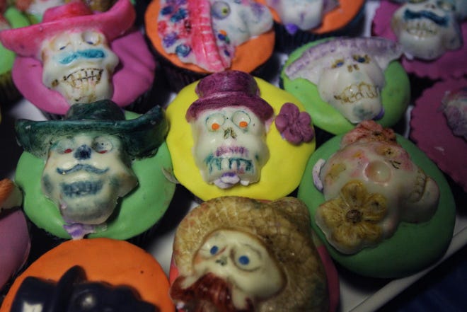 Cupcakes made for the Day of the Dead celebration are topped off with candy skulls, which are intended to "feed" returning spirits.