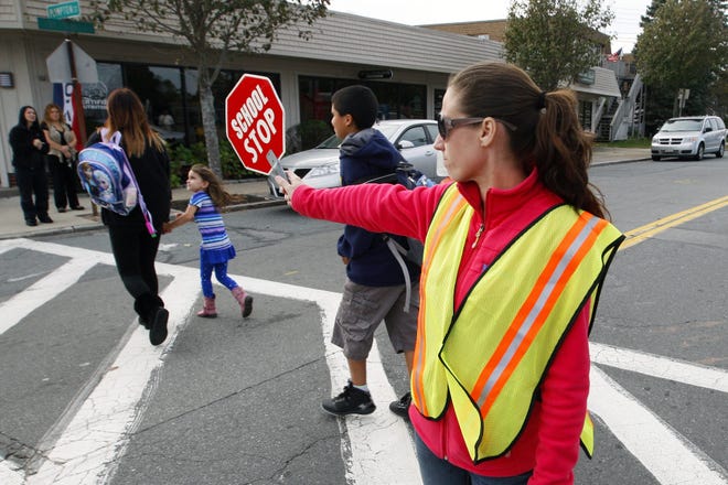 Jennifer Duarte volunteers Tuesday through Friday afternoons on the crosswalk on Tarkiln Hill Road outside of Swift School in New Bedford. JOHN SLADEWSKI/THE STANDARD-TIMES