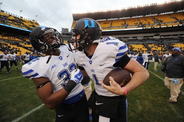 Duke linebacker Chris Holmes, left, and quarterback Thomas Sirk celebrate after beating Pittsburgh. Sirk scored the winning touchdown.