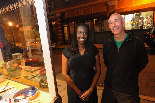 Jennifer Ebisemiju Madar, the new president of Roslindale Village Main Street, and outgoing President Steve Gag, pose for a photo in front of Kitchen Central on Birch Street in Roslindale. Wicked Local staff photo / Kate Flock