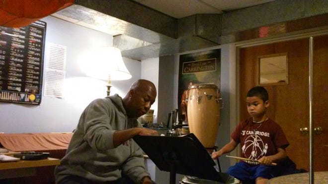 Matteo Benzan, 7, gets his weekly drum lesson from Ron Savage.