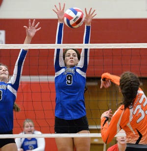 Fort LeBoeuf junior Kaley Fucci, center, blocks a shot by Corry senior Abby Gluvna during the District 10 Class AA volleyball championship at Meadville Area High School in Meadville on Nov. 1. LeBoeuf senior Madison Lydic is at left.  GREG WOHLFORD/