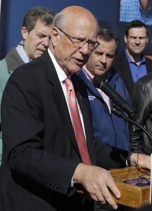With New Jersey Gov. Christie, second from right, Kansas Gov. Sam Brownback, left, in the background, Sen. Pat Roberts, R-Kan., speaks at a campaign rally in Kansas City, Kan., Friday, Oct. 31, 2014. (AP Photo/Orlin Wagner)