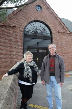 Ellen Eskola-Cunha and Phil Cormier stand in front of Lucy's Barn, the future location of the Stratton Players.