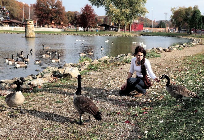 Rosemary Hafliger, of Dover, feeds the ducks and geese at Tuscora Park in New Philadelphia recently.
