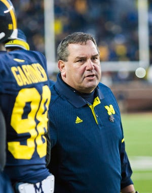 Michigan head coach Brady Hoke watches the action from the sideline in the fourth quarter of an NCAA college football game against Indiana in Ann Arbor, Mich., Saturday, Nov. 1, 2014. Michigan won 34-10. (AP Photo/Tony Ding)