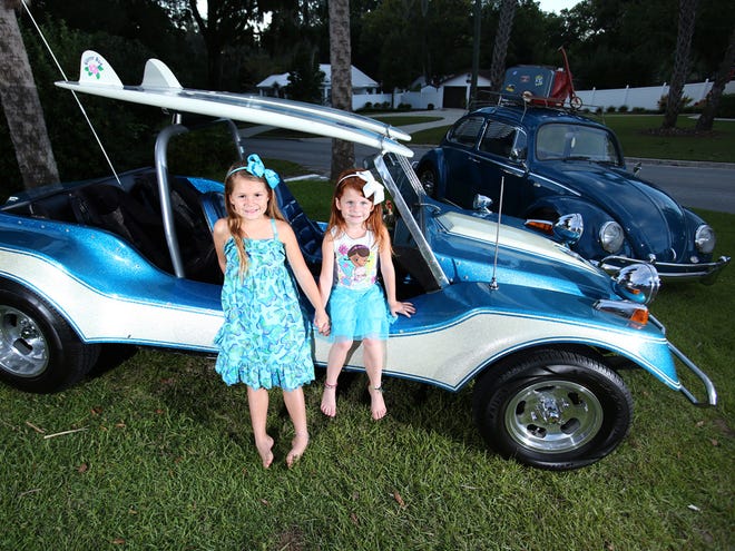 Amelia Brinkley, 6, left, and her sister, Ramsey, 4, right, pose by their parents' 1976 Volkswagen Daytona Allison Dune Buggy at their northeast Ocala home.