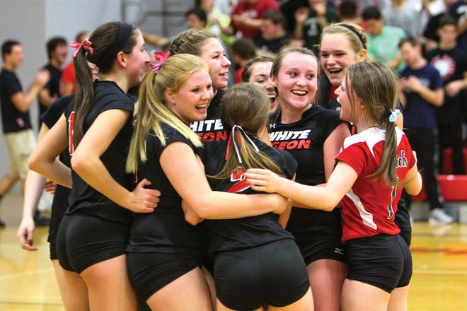The White Pigeon volleyball team celebrates after a win over Centreville on Monday night.