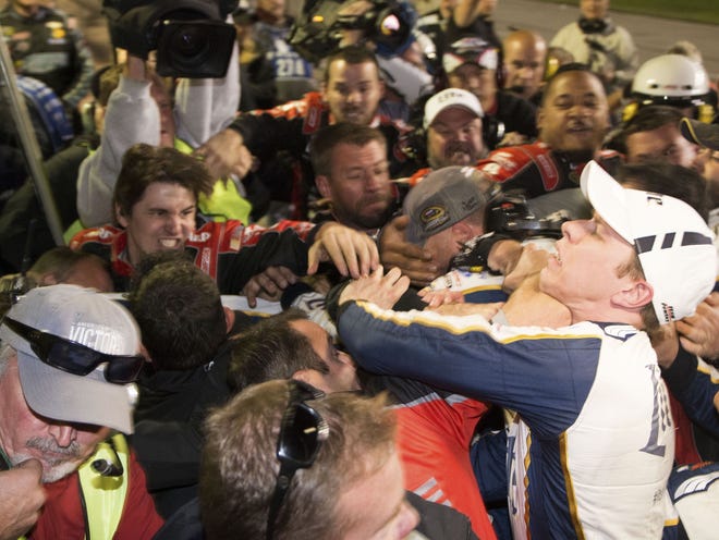 Brad Keselowski, right, is punched during a fight after the NASCAR Sprint Cup Series race at Texas Motor Speedway in Fort Worth, Texas, on Sunday. The crews of Jeff Gordon and Keselowski fought after the race.