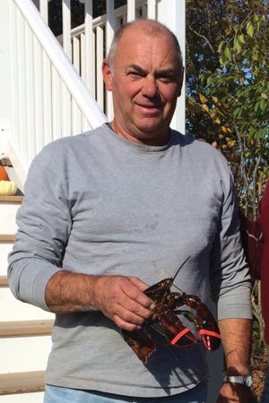 Photo by Sonny Perkins

Don Bardsley holds one of the dozen lobsters he recently won.