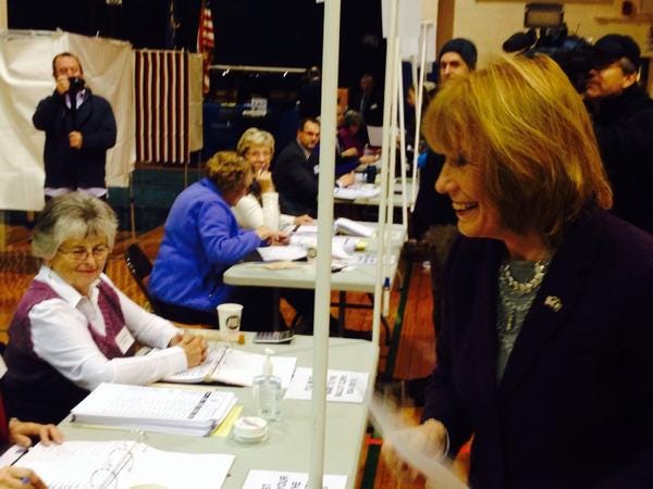 Gov. Maggie Hassan receives her ballot and headed into the booth to vote at the Exeter polls on Tuesday morning.