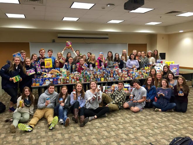 Exeter High School students recently held a trick-or-canning drive, collecting canned goods and non-perishables to benefit the St. Vincent de Paul food pantry. Here they are pictured with the items collected.

Courtesy photo